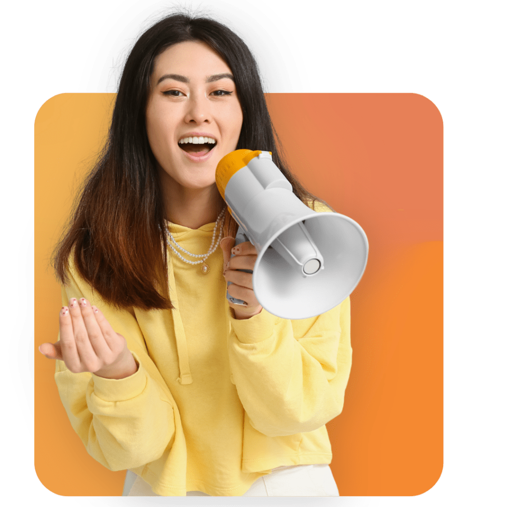 Young woman in a yellow hoodie smiling and holding a megaphone, gesturing with her other hand, standing in front of an orange background—ready to promote the best executive assistant service.